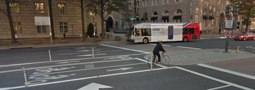 Google Streetview Image of Pennsylvania Ave bike lanes with intersection showing crossing sign